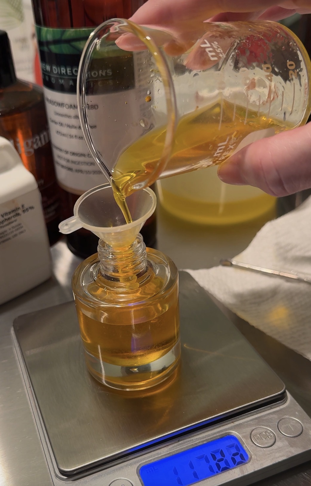 Pouring oil into soap recipe